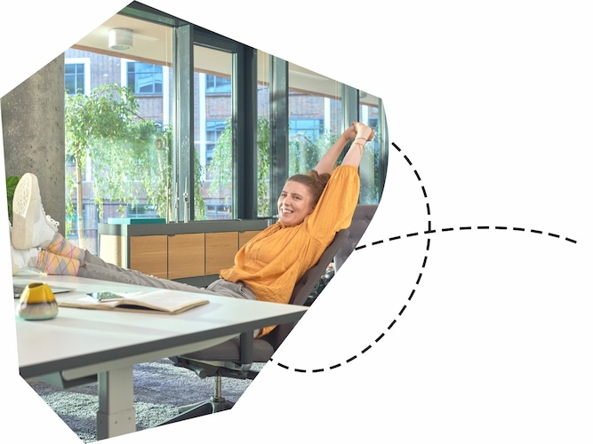 Happy woman leaning back and stretching on an office chair